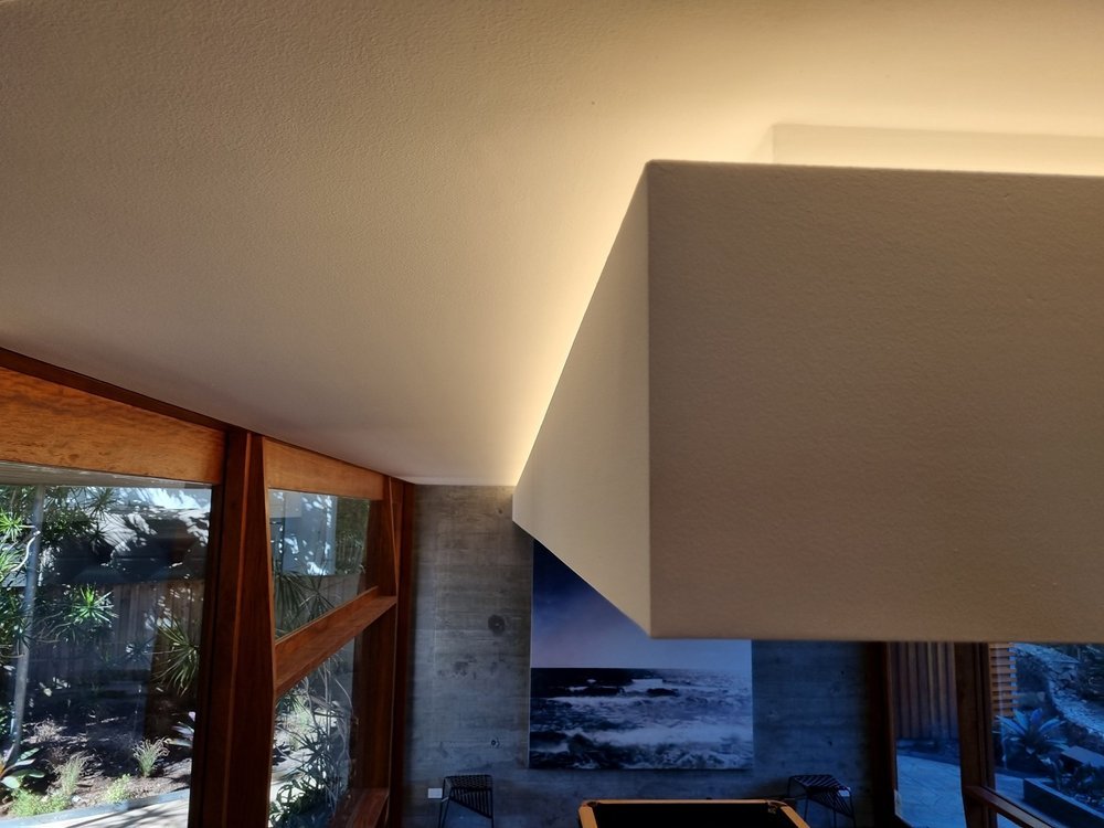 Warm concealed LED lighting at the top of an interior wall
