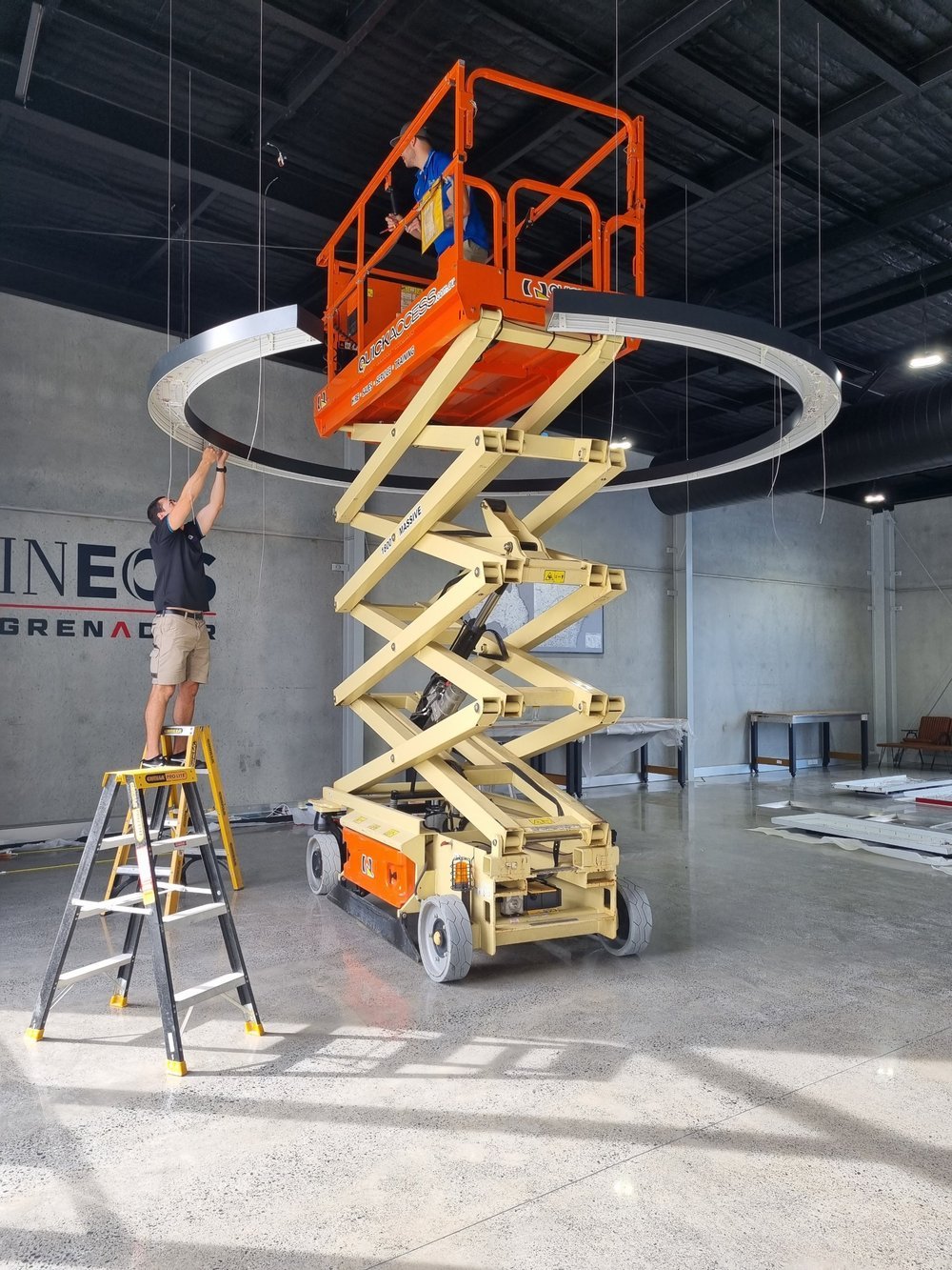 Commercial ceiling light installation using a scissor lift